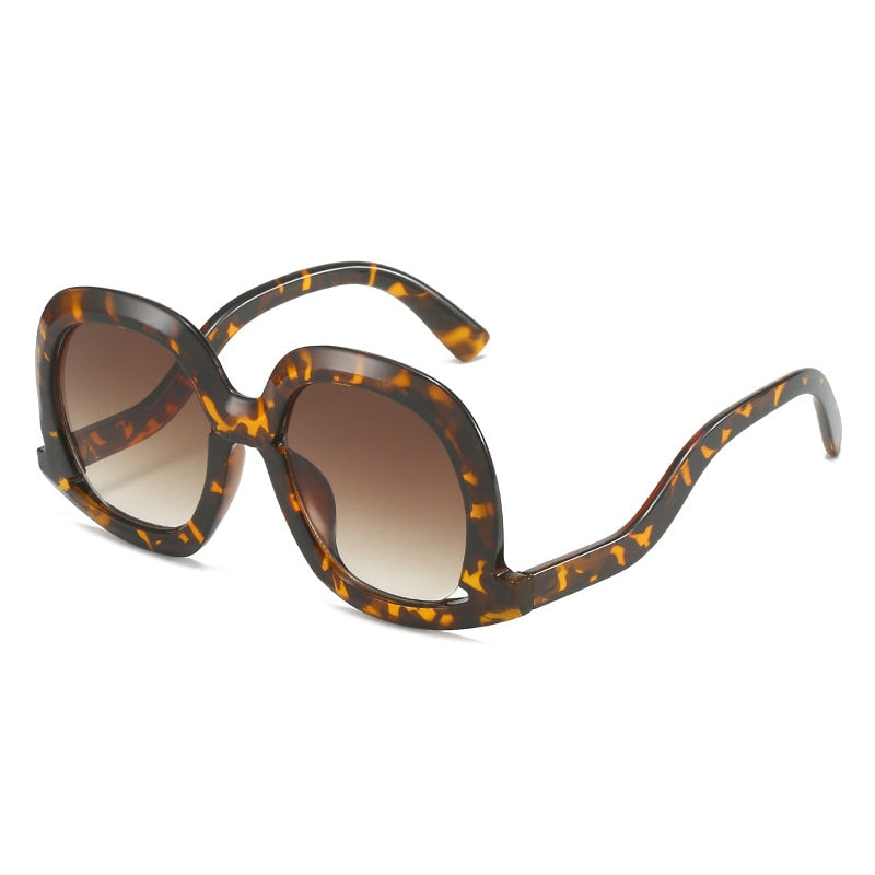 Gafas de sol ovaladas únicas de moda para mujer, gafas de sol huecas de tendencia con degradado de leopardo colorido para hombre y mujer con protección UV400 